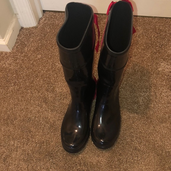 red rain boots with bow on back